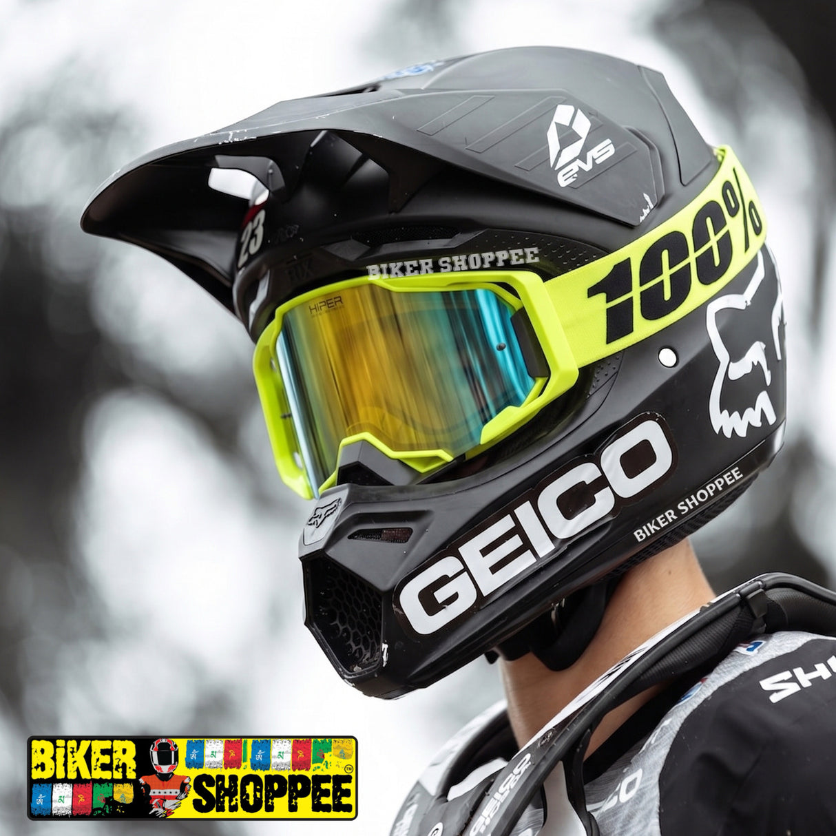A close-up of a black full-face mountain bike helmet with bright neon yellow goggles and a reflective yellow lens. The helmet features prominent white branding for 'GEICO' and '100%'.