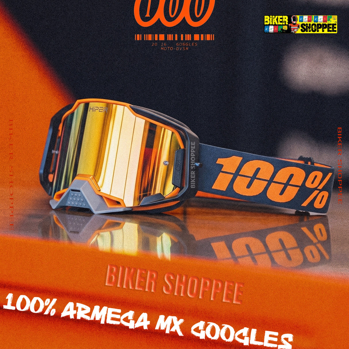 100% Armega MX 400goggles in orange and black with a reflective gold mirror lens, displayed on an orange reflective surface with promotional text overlays.